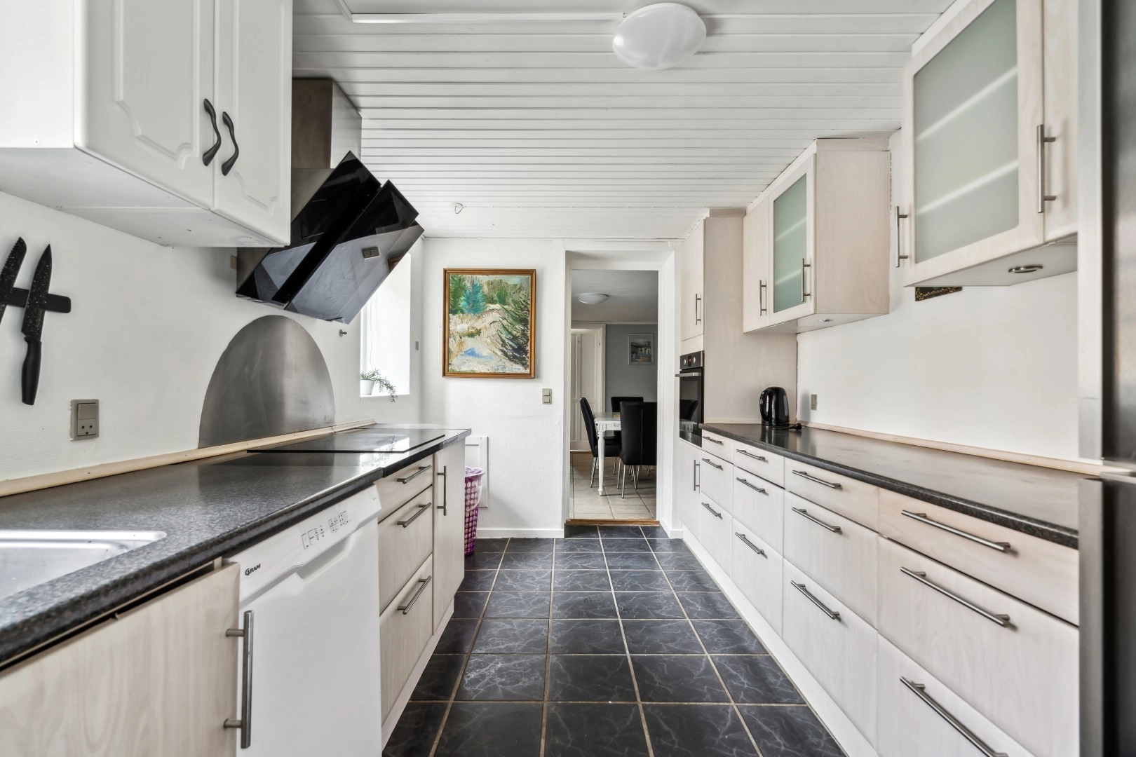 White kitchen with black floor in rental